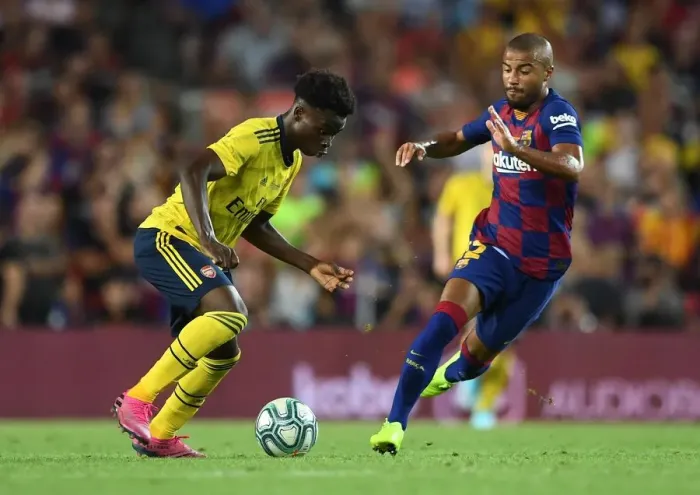 Framed Print : Bukayo Saka vs Rafinha: FC Barcelona vs Arsenal Pre-Season Clash at Nou Camp (2019-20)