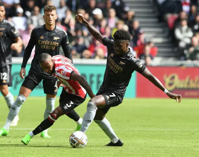 Framed Print : Bukayo Saka vs Rico Henry: Intense Battle at Brentford Community Stadium - Arsenal vs Brentford, Premier League 2022-23