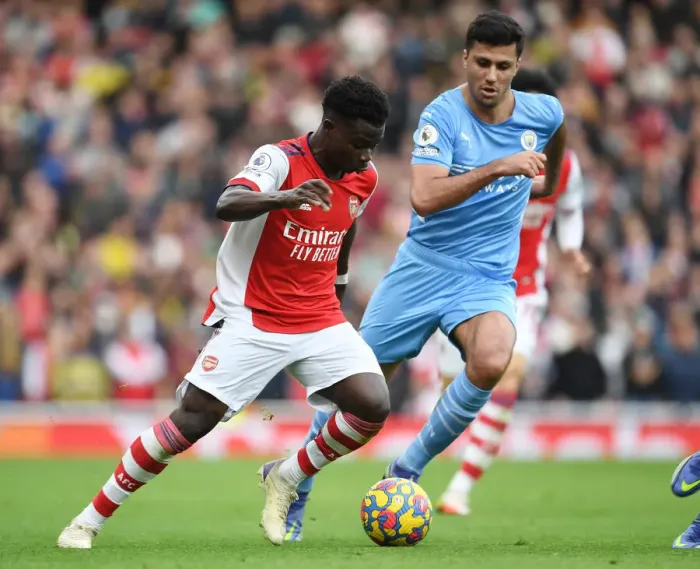 Framed Print : Bukayo Saka vs. Rodri: Intense Showdown in Arsenal vs. Manchester City Clash