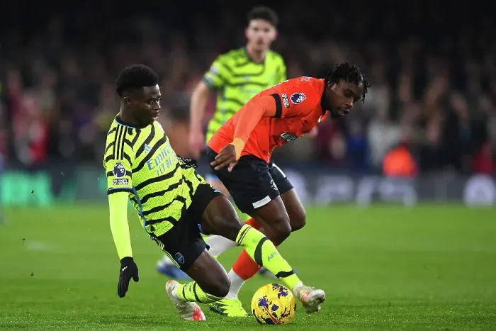 Framed Print : Bukayo Saka vs Teden Mengi: Intense Battle in Luton Town vs Arsenal FC, Premier League 2023-24