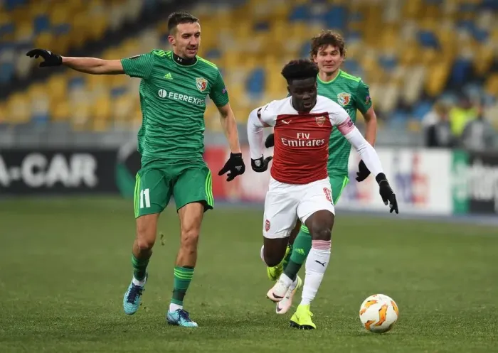 Framed Print : Bukayo Saka vs. Vyacheslav Sharpar: Arsenal's Rising Star Faces Off Against Vorskla Defender in Europa League Clash Framed Print : Bukayo Saka vs. Vyacheslav Sharpar: Arsenal's Rising Star Faces Off Against Vorskla Defender in Europa League Clash