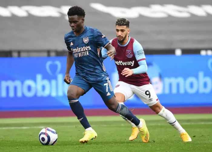 Framed Print : Bukayo Saka's Agile Moves: Arsenal's Empty-Stadium Triumph Over West Ham, Premier League 2020-21