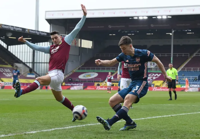 Framed Print : Burnley vs. Arsenal: Tierney Tangles with Lowton Amid Empty Turf Moor