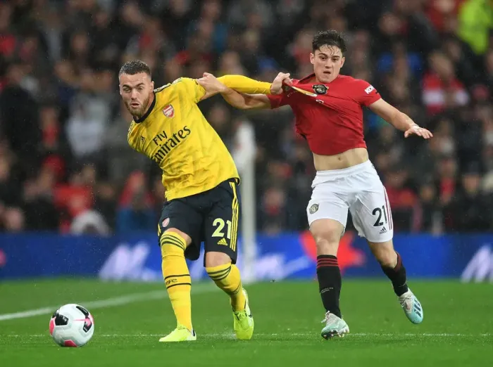 Framed Print : Calum Chambers Evades Daniel James: A Tense Moment from the Manchester United vs Arsenal Premier League Clash (2019-20)