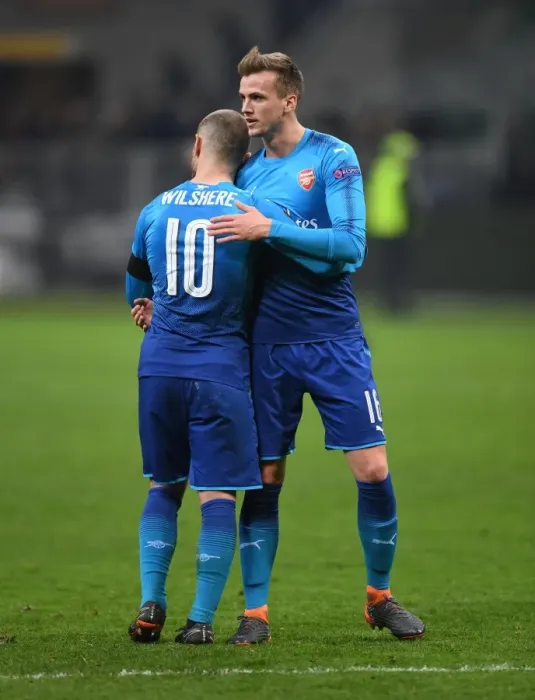 Framed Print : Camaraderie on the Field: Holding and Wilshere's Heartwarming Moment After Arsenal's Europa League Clash Against AC Milan Framed Print : Camaraderie on the Field: Holding and Wilshere's Heartwarming Moment After Arsenal's Europa League Clash Against AC Milan