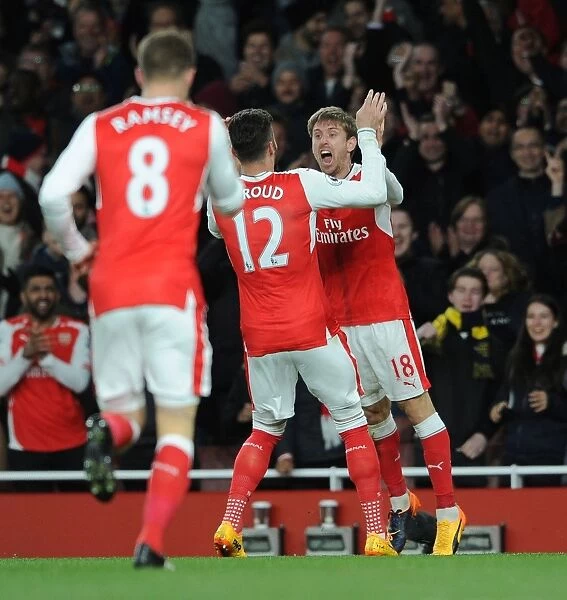 Celebrating the Goal: Monreal and Giroud's Moment of Triumph for Arsenal against Leicester City