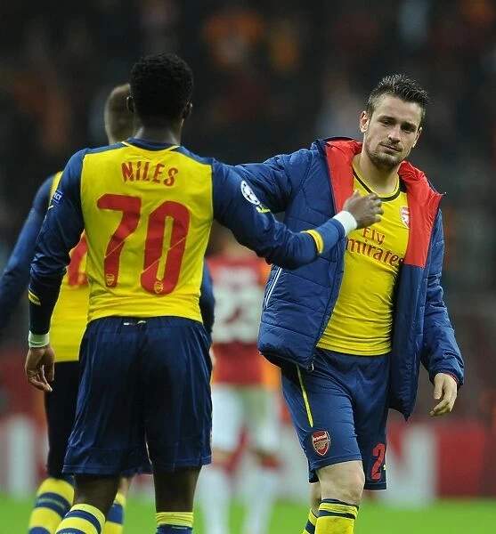 Celebrating Victory: Debuchy and Maitland-Niles High-Five After Arsenal's Win Against Galatasaray