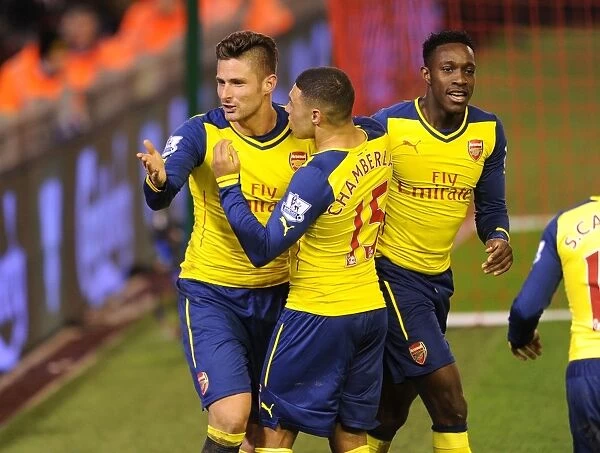 Celebrating Victory: Giroud, Oxlade-Chamberlain, and Welbeck Rejoice After Arsenal's Goals vs. Liverpool (2014 / 15)