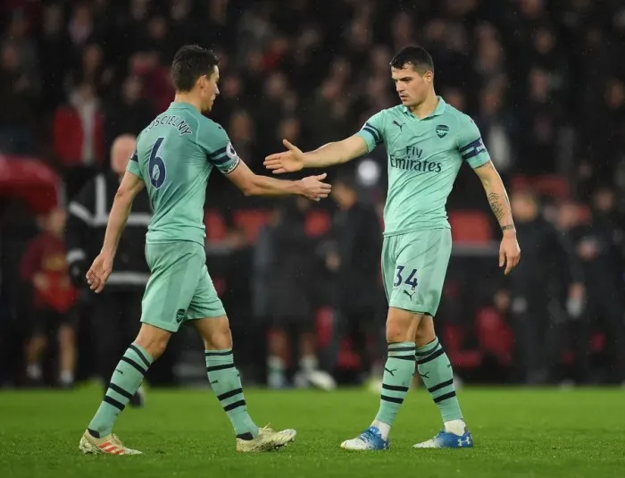 Framed Print : Celebrating Victory: Koscielny and Xhaka High-Five After Arsenal's Win Against Southampton (2018-19)