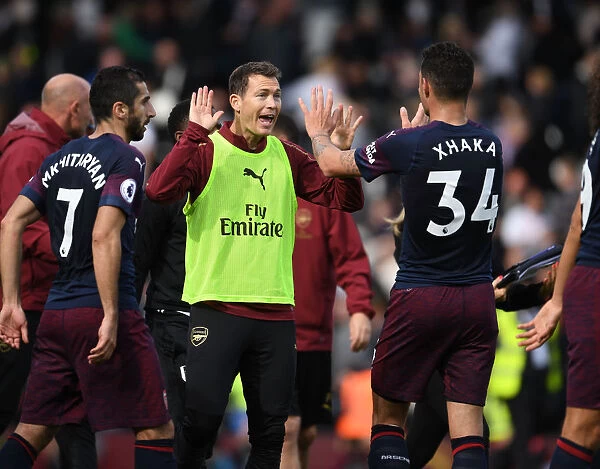 Celebrating Victory: Lichtsteiner and Xhaka Rejoice After Arsenal's Win Against Fulham