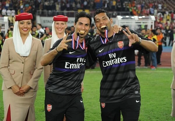 Celebrating Victory: Mikel Arteta and Andre Santos of Arsenal