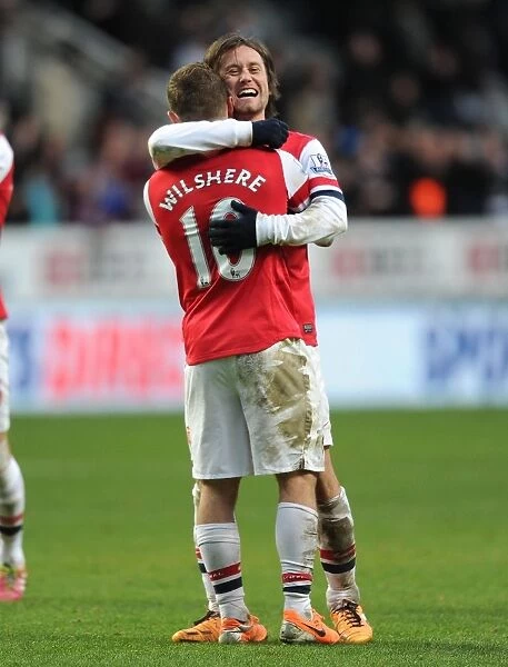 Celebrating Victory: Rosicky and Wilshere Rejoice after Arsenal's Win against Newcastle United (2013-14)