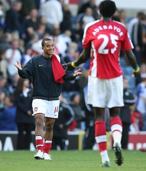 Celebrating Victory: Theo Walcott and Emmanuel Adebayor, Arsenal's Unstoppable Duo