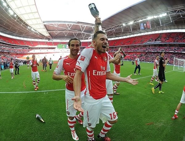 Celebration at the Community Shield: Flamini and Ramsey's Emotional Moment after Arsenal's Win over Manchester City