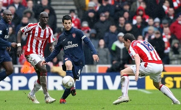 Cesc Fabregas (Arsenal) Dean Whitehead and Mamady Sidibe (Stoke). Stoke City 3: 1 Arsenal