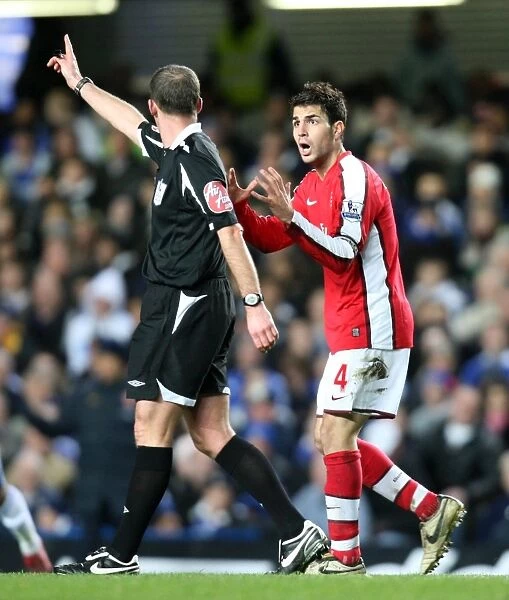 Cesc Fabregas (Arsenal) and Referee Mike Dean