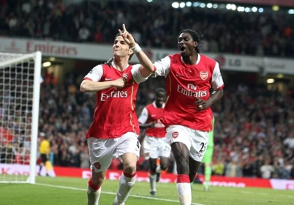 Cesc Fabregas celebrates scoring Arsenals 2nd goal with Emmanuel Adebayor