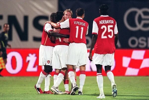 Cesc Fabregas celebrates scorong the 3rd Arsenal goal with Alex Hleb