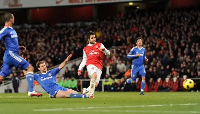 Framed Print : Cesc Fabregas scores Arsenals 2nd goal under pressure from Branislav Invanovic