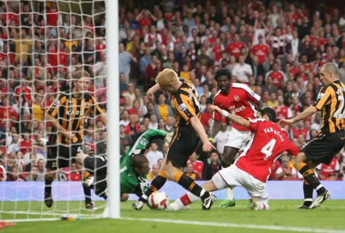 Framed Print : Cesc Fabregas scores Arsenals goal under pressure from Paul McShane