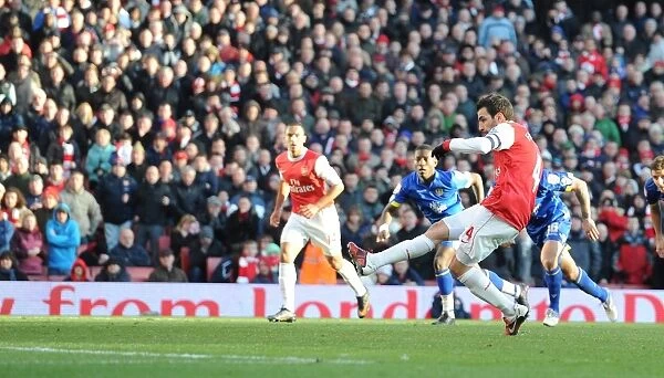 Cesc Fabregas shoots past Leeds goalkeeper Kasper Schmeichel to score the Arsenal goal