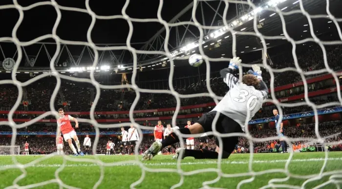 Framed Print : Cesc Fabregas shoots past Shakhtar goalkeeper Andriy Pyatov score the 3rd Arsenal goal