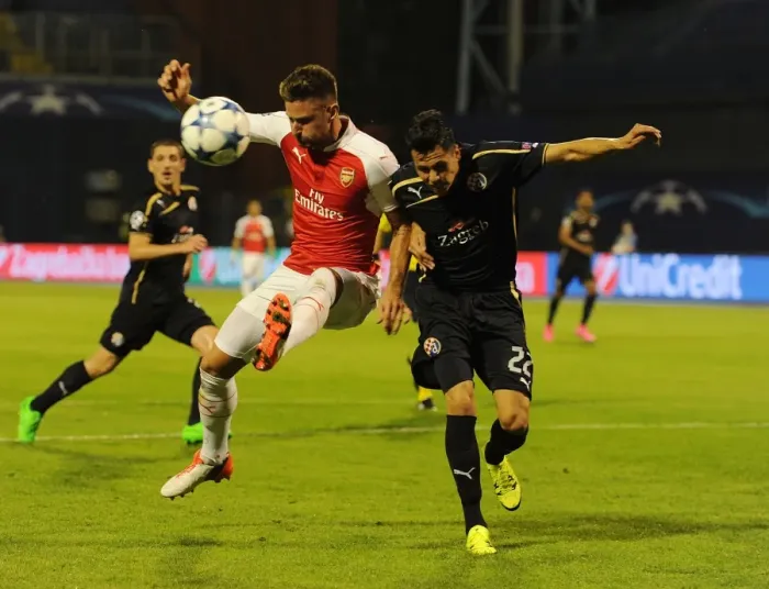 Framed Print : Champions Clash: Olivier Giroud vs. Leonardo Taravel - Arsenal's Star Forward Faces Off Against Dinamo Zagreb's Defender in the 2015-16 UEFA Champions League