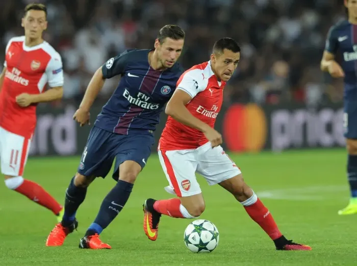 Framed Print : Champions League Showdown: Sanchez vs. Krychowiak - Paris Saint-Germain vs. Arsenal: A Battle of Stars at Parc des Princes