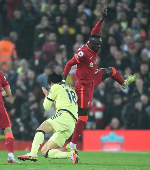 Framed Print : Clash at Anfield: Liverpool vs. Arsenal - Tomiyasu Fouls Mane Framed Print : Clash at Anfield: Liverpool vs. Arsenal - Tomiyasu Fouls Mane