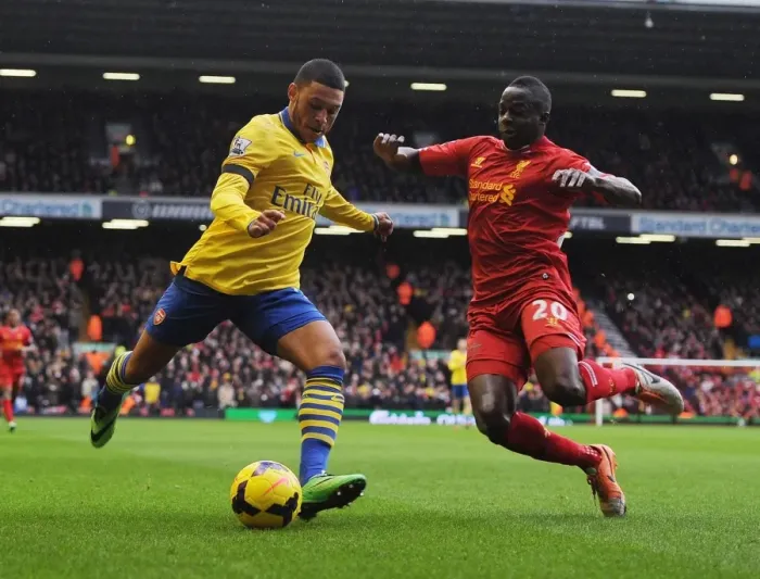 Framed Print : Clash at Anfield: Oxlade-Chamberlain vs. Cissokho in the Premier League Battle