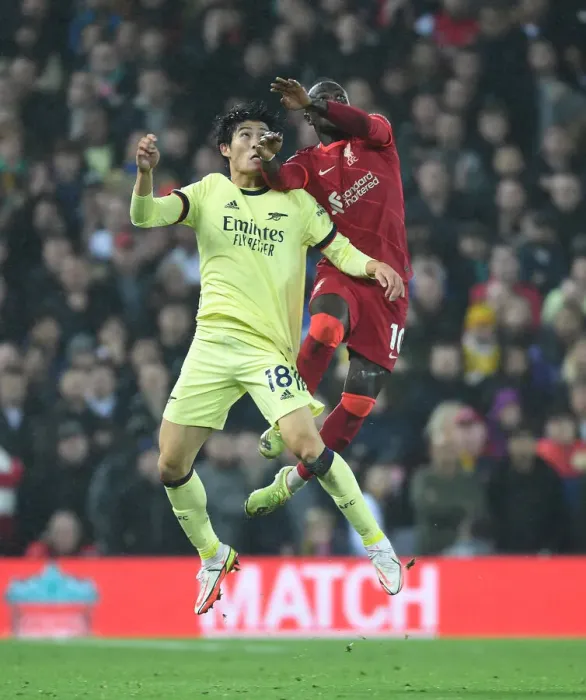 Framed Print : Clash at Anfield: Tomiyasu vs. Mane - Intense Rivalry Erupts in Premier League Football Framed Print : Clash at Anfield: Tomiyasu vs. Mane - Intense Rivalry Erupts in Premier League Football