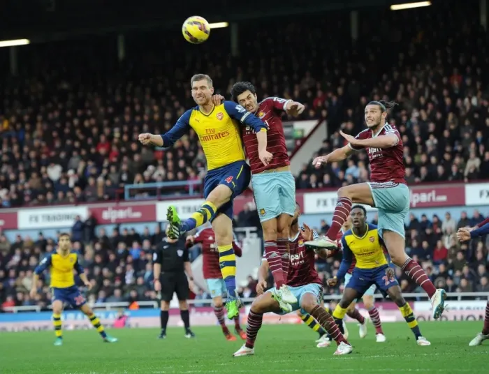 Framed Print : Clash at the Boleyn: Mertesacker Faces Off Against Carroll and Tomkins