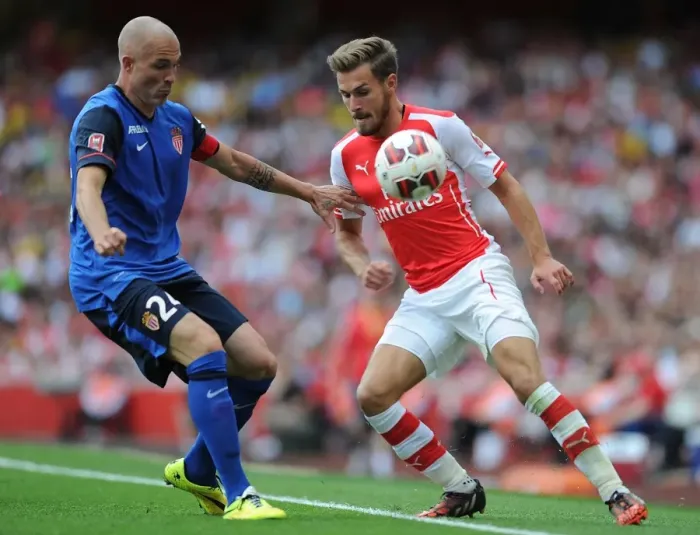 Framed Print : Clash of Champions: Ramsey vs. Raggi - Arsenal's Ramsey Goes Head-to-Head with AS Monaco's Raggi in Thrilling Emirates Cup Encounter