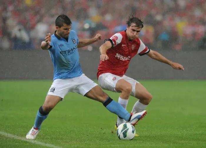 Framed Print : Clash in China: Arsenal's Miquel Tackles Manchester City's Agüero
