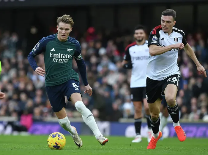 Framed Print : Clash at Craven Cottage: Arsenal's Martin Odegaard Fends Off Fulham's Joao Palhinha Framed Print : Clash at Craven Cottage: Arsenal's Martin Odegaard Fends Off Fulham's Joao Palhinha