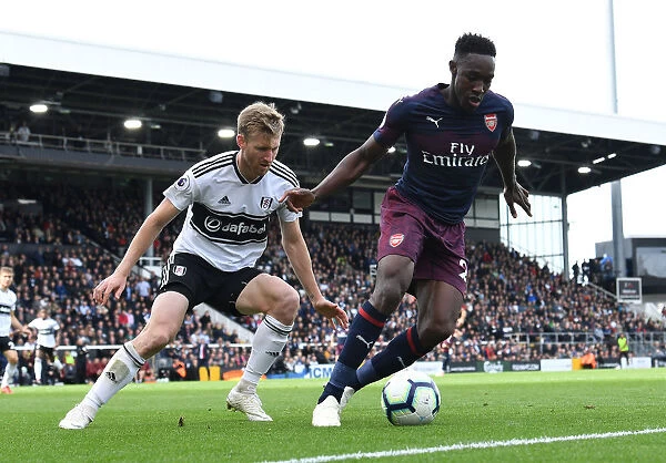 Clash at Craven Cottage: Fulham's Tim Ream Holds Off Arsenal's Danny Welbeck