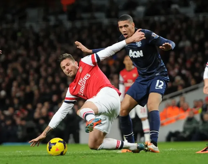 Framed Print : Clash at the Emirates: Giroud vs Smalling - Arsenal vs Manchester United, Premier League 2013-14