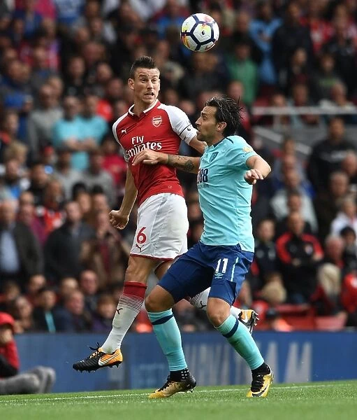 Clash at Emirates: Koscielny vs Daniels in Intense Heading Duel (Arsenal v AFC Bournemouth, 2017-18)