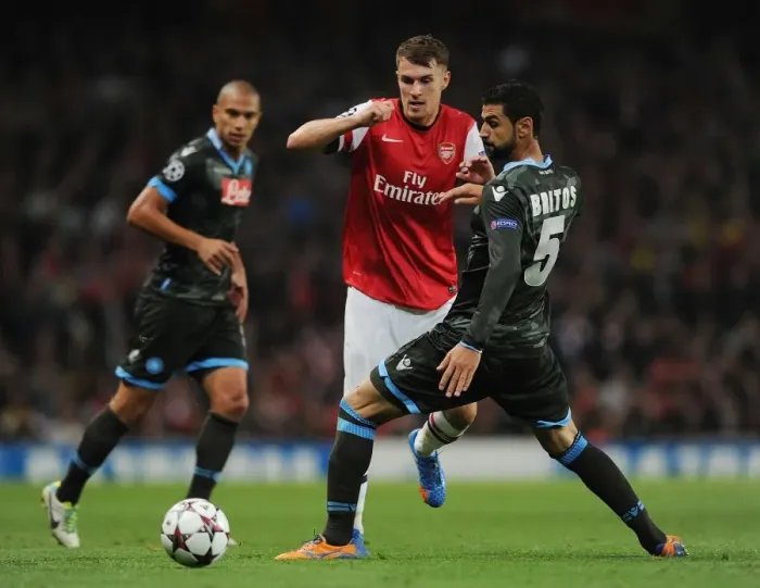 Framed Print : Clash of Forces: Ramsey vs. Britos in Arsenal vs. Napoli UEFA Champions League Showdown