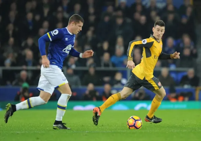 Framed Print : Clash at Goodison Park: Koscielny vs. Barkley in the Premier League Battle between Everton and Arsenal Framed Print : Clash at Goodison Park: Koscielny vs. Barkley in the Premier League Battle between Everton and Arsenal