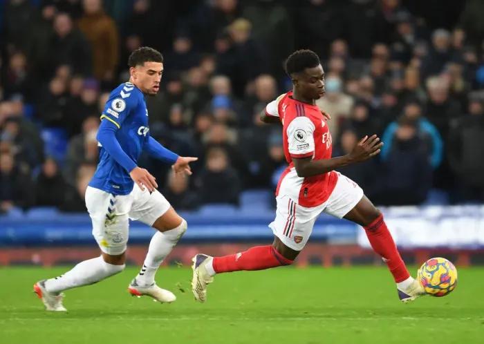Framed Print : Clash at Goodison Park: Saka vs. Godfrey in Everton vs. Arsenal Premier League Showdown Framed Print : Clash at Goodison Park: Saka vs. Godfrey in Everton vs. Arsenal Premier League Showdown