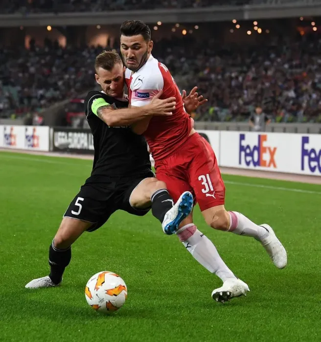Framed Print : Clash of Kolasinac and Medvedev: A Battle in Baku's Europa League