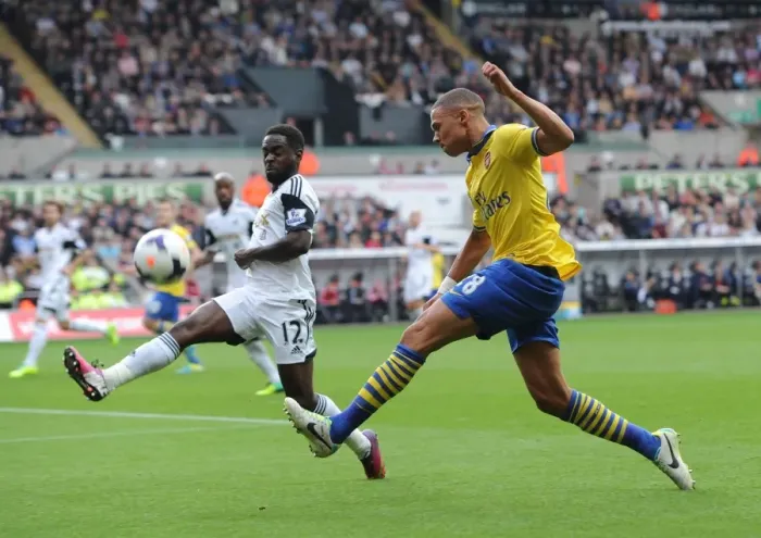 Framed Print : Clash at Liberty: Gibbs vs. Dyer in Swansea-Arsenal Premier League Showdown