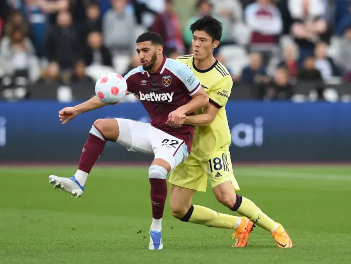 Framed Print : Clash at London Stadium: Arsenal's Tomiyasu Faces Off Against West Ham's Benrahma Framed Print : Clash at London Stadium: Arsenal's Tomiyasu Faces Off Against West Ham's Benrahma