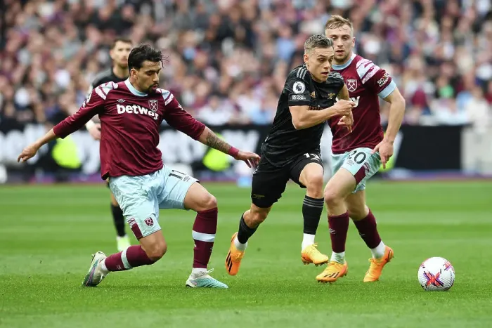 Framed Print : Clash at London Stadium: Arsenal's Trossard Faces Off Against West Ham's Paqueta and Bowen