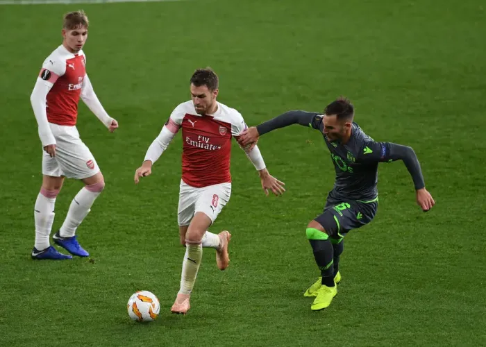 Framed Print : Clash of Midfield Maestros: Ramsey vs. Gudelj in Arsenal's Europa League Battle Framed Print : Clash of Midfield Maestros: Ramsey vs. Gudelj in Arsenal's Europa League Battle