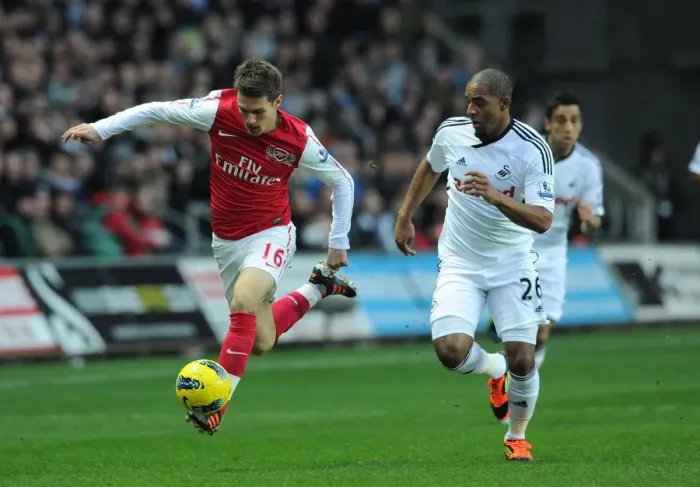 Framed Print : Clash of Midfield Titans: Ramsey vs. Agustien, Swansea City vs. Arsenal, 2012 Framed Print : Clash of Midfield Titans: Ramsey vs. Agustien, Swansea City vs. Arsenal, 2012