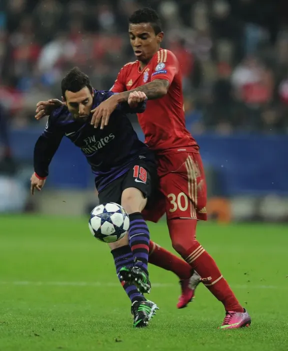 Framed Print : Clash of Midfield Titans: Santi Cazorla vs. Luiz Gustavo - Arsenal vs. Bayern Munich, UEFA Champions League 2013