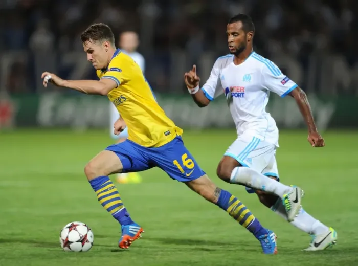 Framed Print : Clash of Midfielders: Ramsey vs. Imbula - Marseille vs. Arsenal, UEFA Champions League, 2013