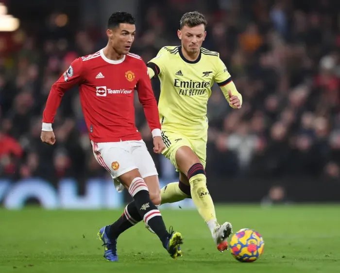 Framed Print : Clash at Old Trafford: Arsenal's White Holds Off Ronaldo in Manchester United vs Arsenal Premier League Showdown